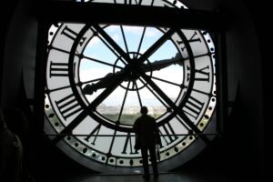 a man standing near the clock tower