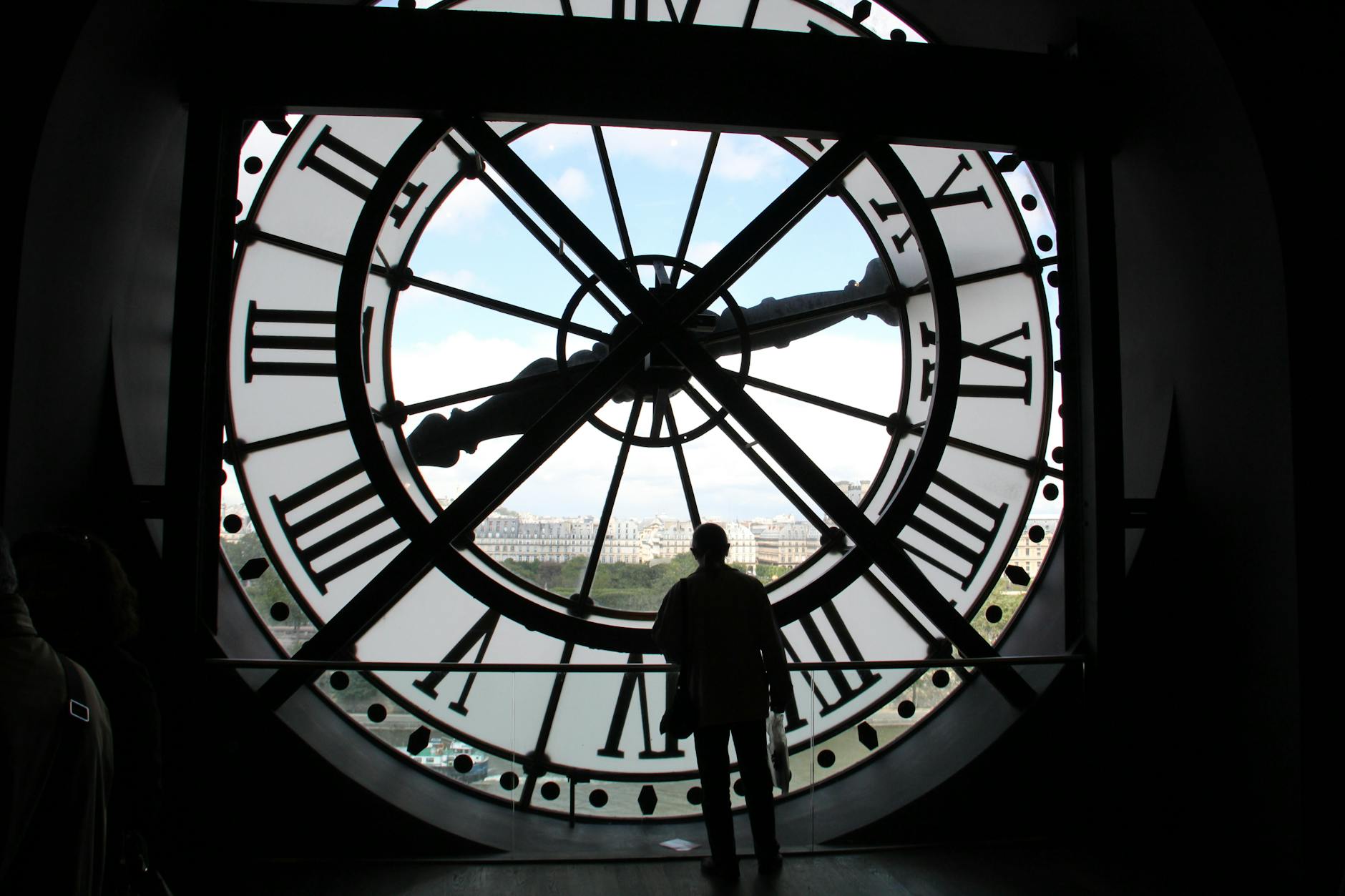 a man standing near the clock tower